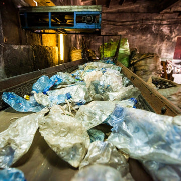 Plastic waste on a conveyor belt in an industrial setting